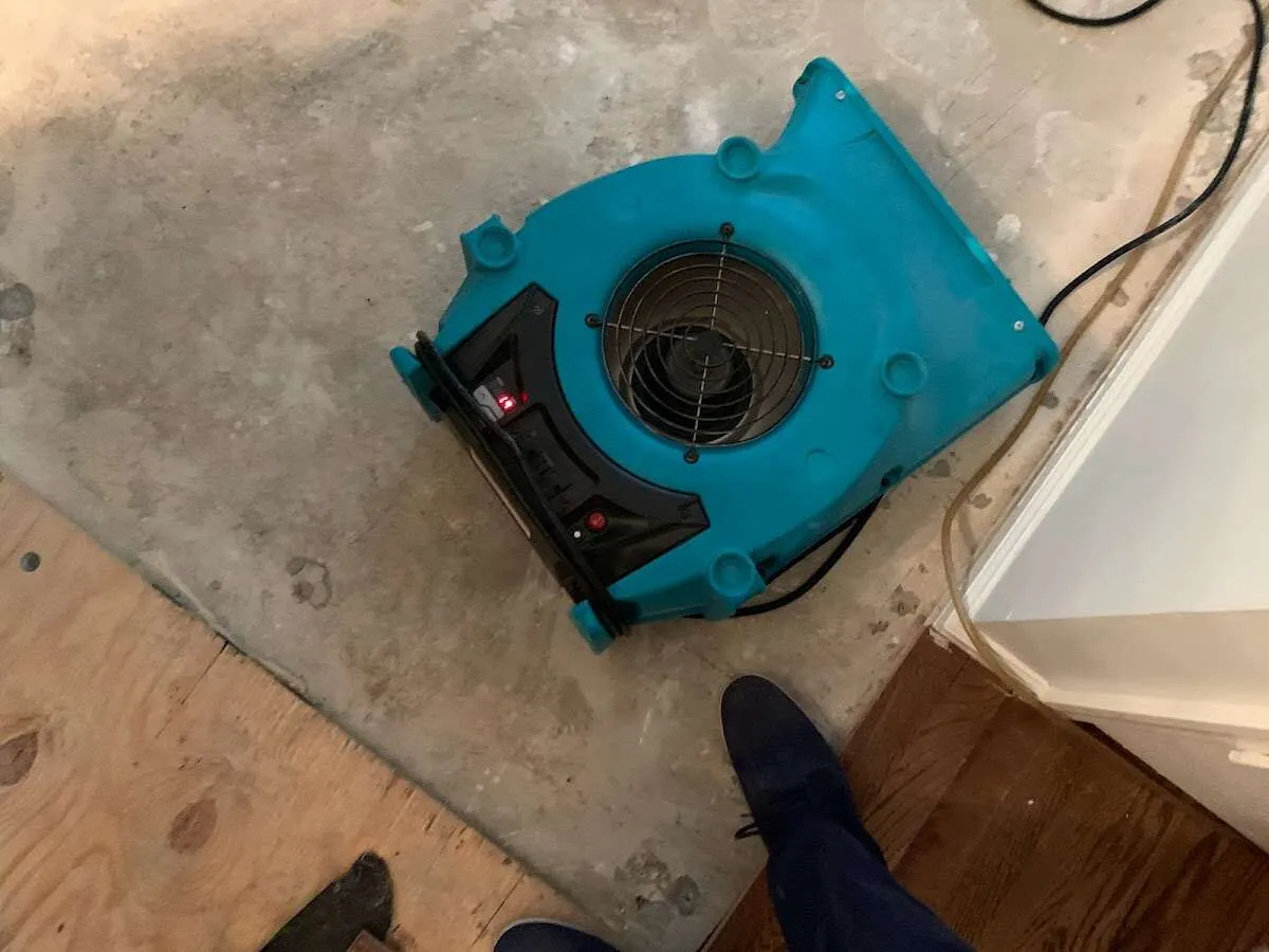 Air mover drying subfloor during Commercial Water Damage Restoration in Corning